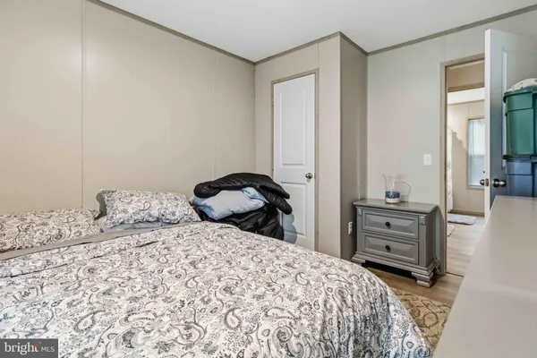 a bedroom with a bed and a dresser