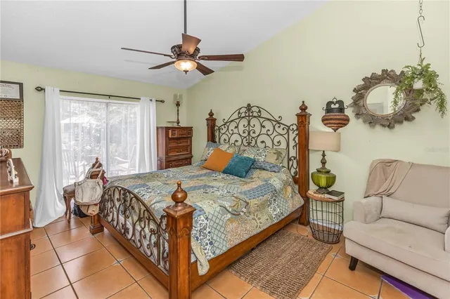 a bedroom with a bed and a mirror on the dresser