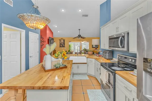 a kitchen with stainless steel appliances granite countertop a stove and a sink