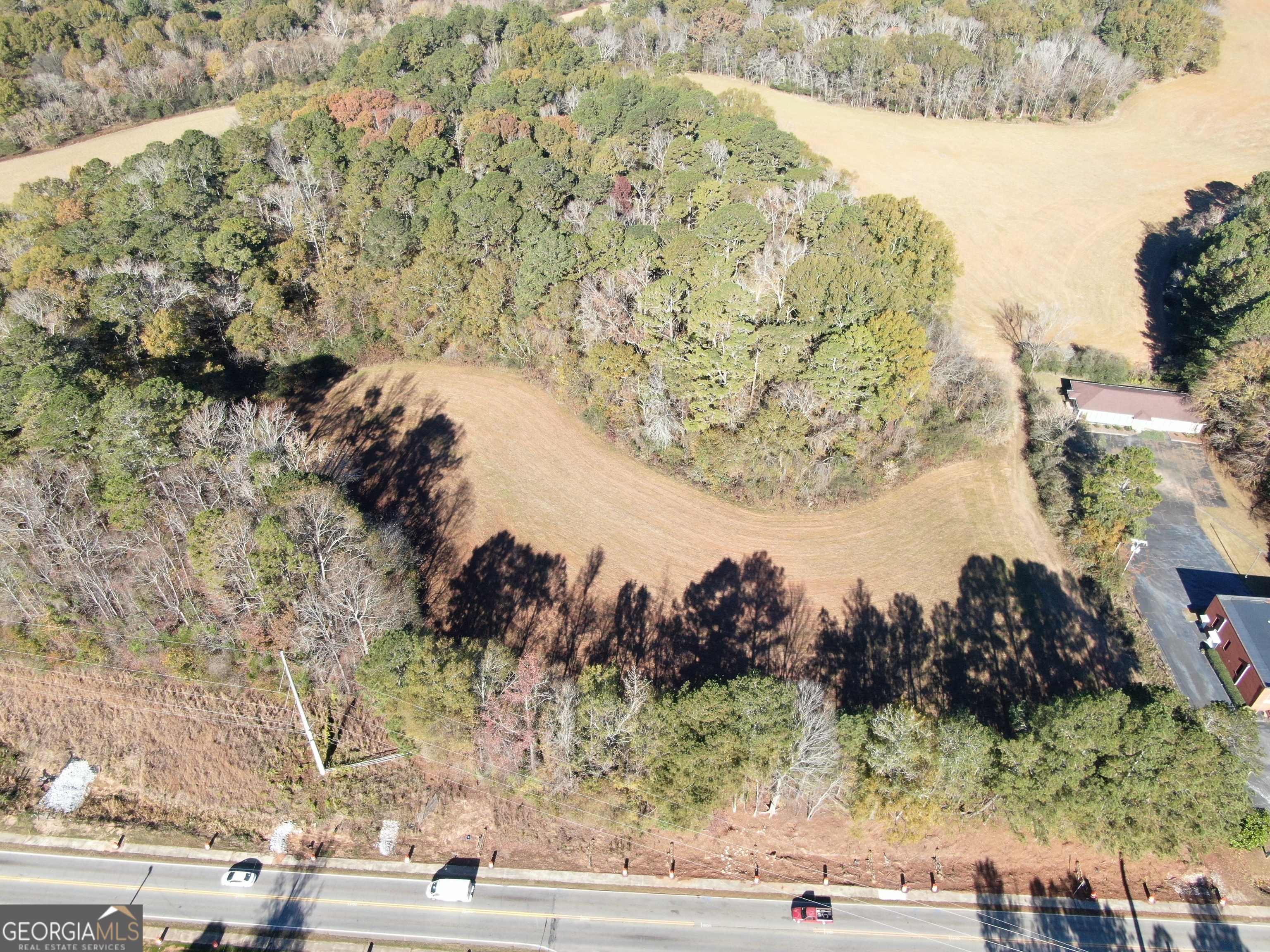 a view of a yard with wooden fence