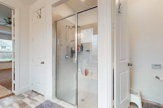 a bathroom with a glass shower door