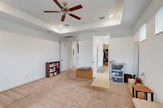 a living room with furniture and a ceiling fan