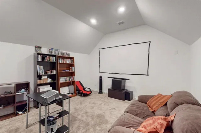 a living room with furniture a rug and a book shelf