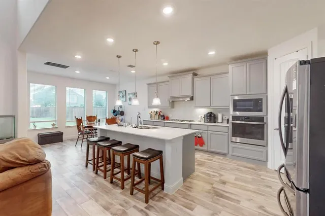 a kitchen with counter top space a sink appliances and cabinets