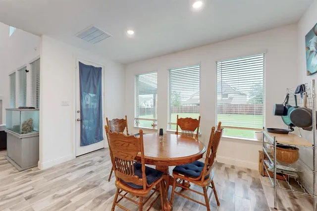 a dining room with furniture and wooden floor