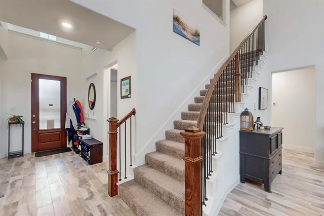 a view of entryway with wooden floor and stairs