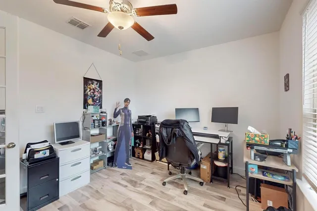 a view of a workspace with furniture and gym equipment