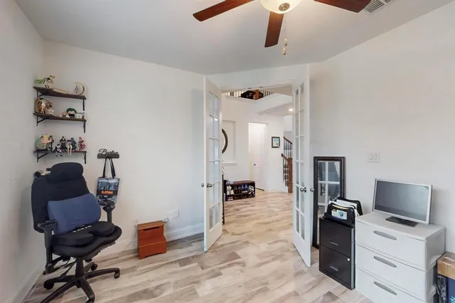 a view of a workspace with furniture and gym equipment