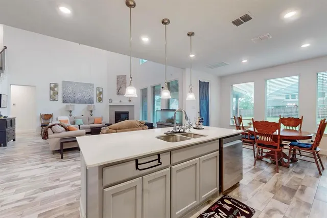 a large kitchen with a table and chairs