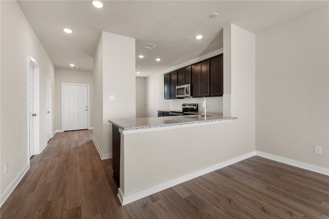 2427 Rooke Road Bryan, TX 77807 - Photo 17 of 38 a view of kitchen with cabinets and wooden floor