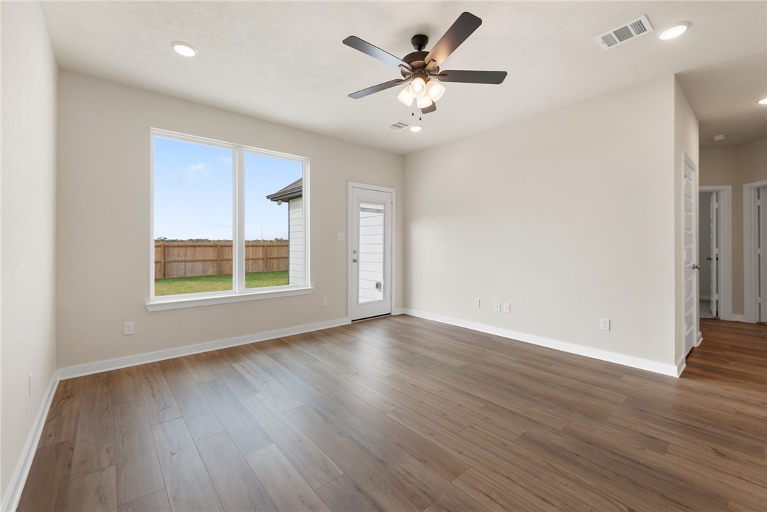 2427 Rooke Road Bryan, TX 77807 - Photo 19 of 38 an empty room with wooden floor and windows
