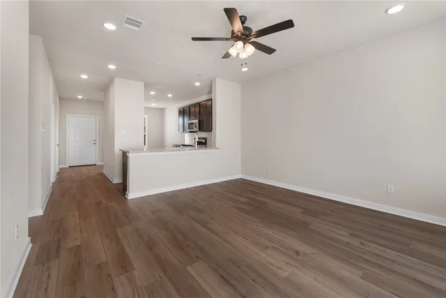 a view of a livingroom with a hardwood floor and a ceiling fan