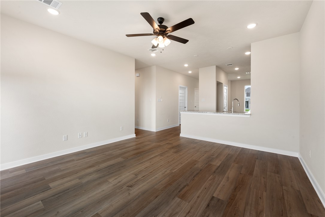 2427 Rooke Road Bryan, TX 77807 - Photo 22 of 38 an empty room with wooden floor and a ceiling fan