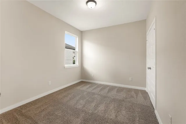 a view of an empty room with windows