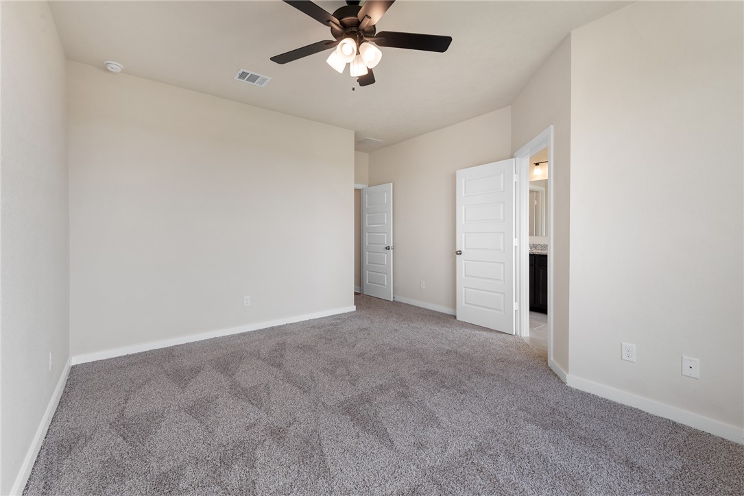 2427 Rooke Road Bryan, TX 77807 - Photo 31 of 38 an empty room with chandelier fan and windows