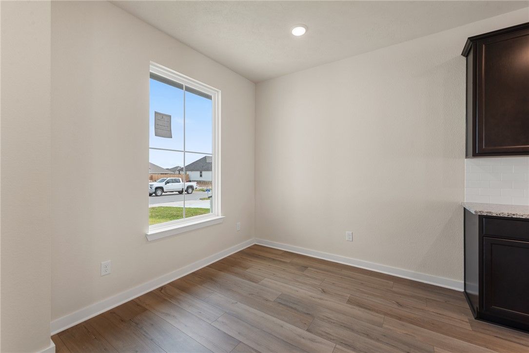 2427 Rooke Road Bryan, TX 77807 - Photo 7 of 38 a view of an empty room with wooden floor and a window
