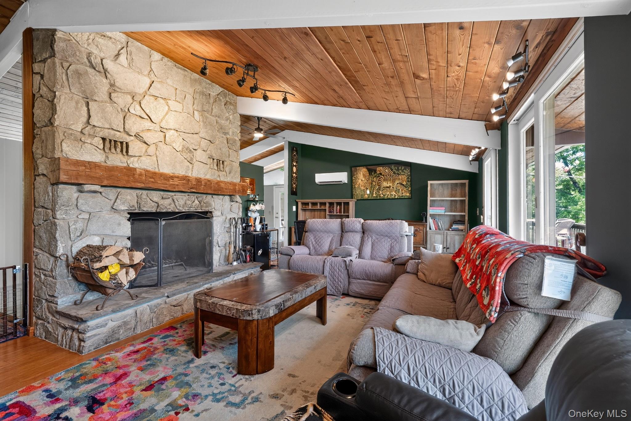 Stone fireplace with a substantial timber mantel