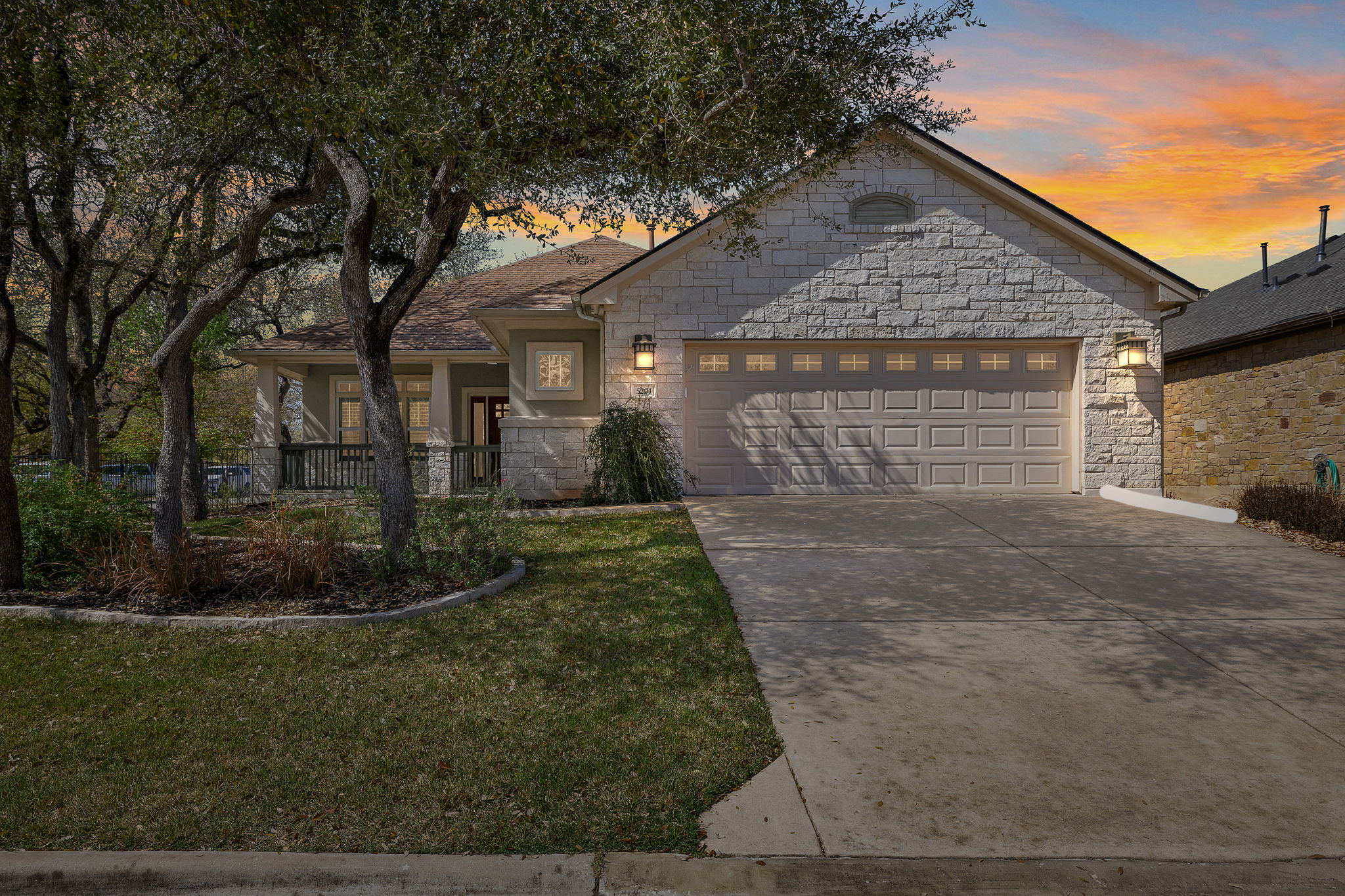 5201 Big Spring Street Georgetown, TX 78633 - Photo 2 of 26 View of front of home featuring a garage, driveway, stone siding, and a lawn