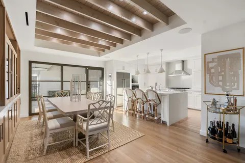 a dining room with furniture and wooden floor