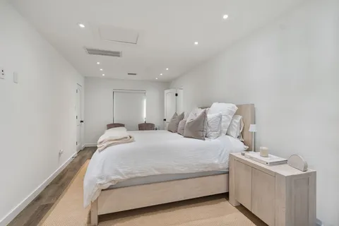 a bedroom with a bed and a night stand