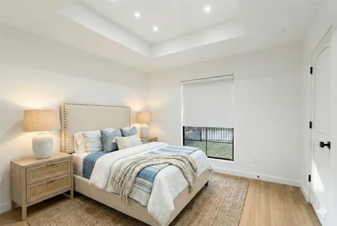 a bedroom with a bed and a night stand