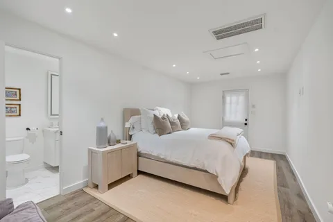 a spacious bedroom with a bed and a couch