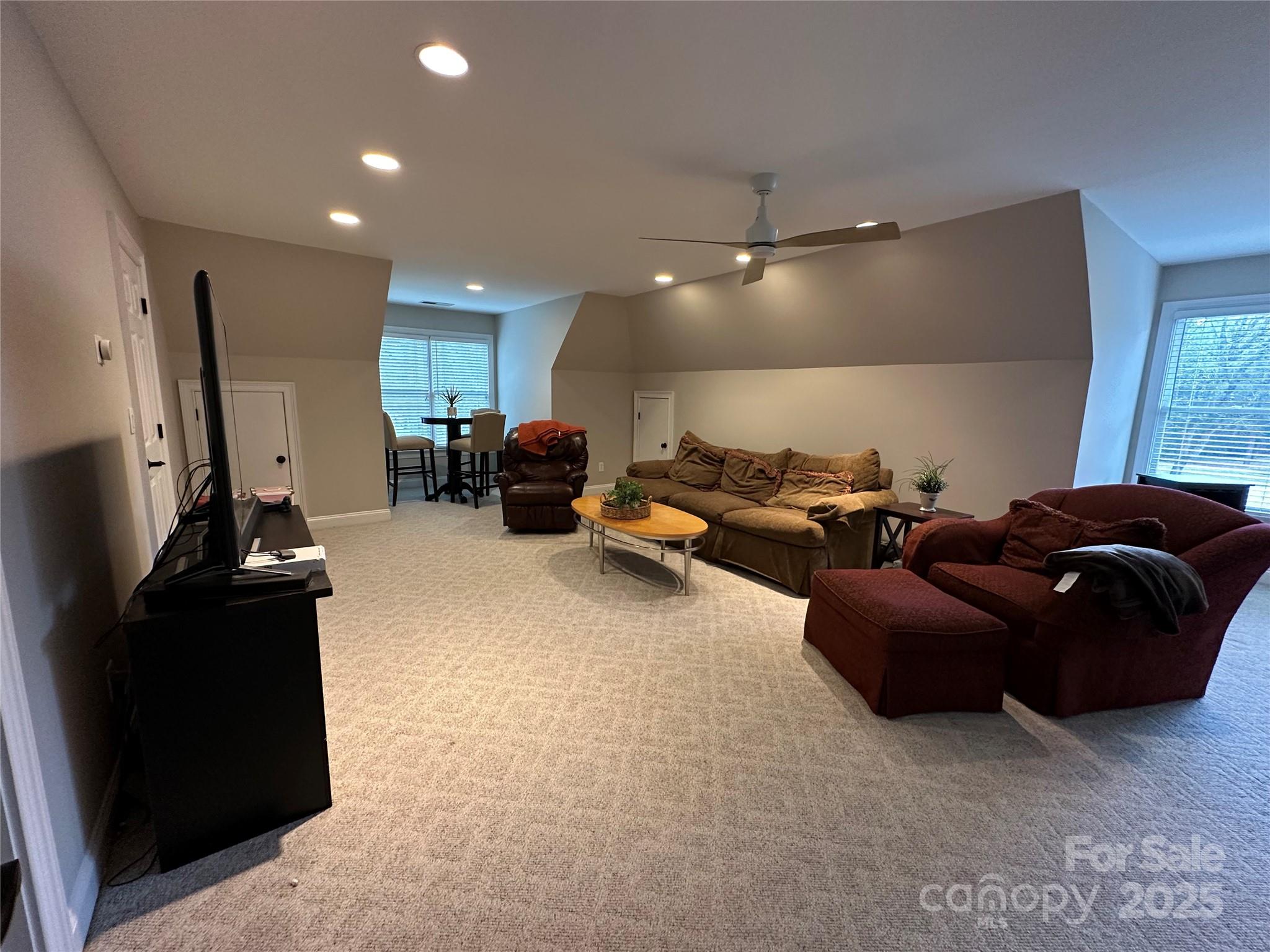 19622 River Falls Drive Davidson, NC 28036 - Photo 12 of 25 a living room with furniture and a flat screen tv