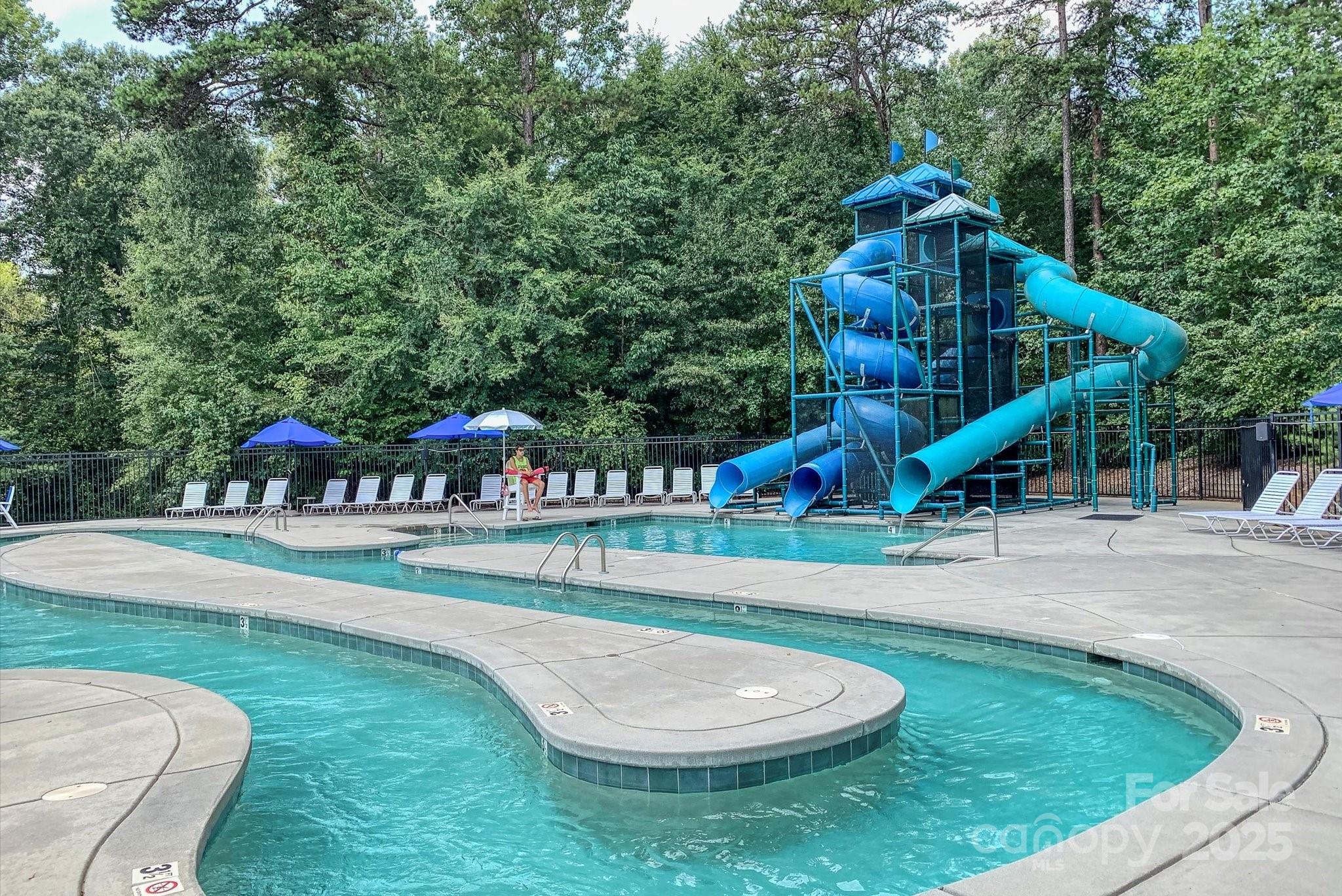 19622 River Falls Drive Davidson, NC 28036 - Photo 21 of 25 an outdoor space with swimming pool and trees