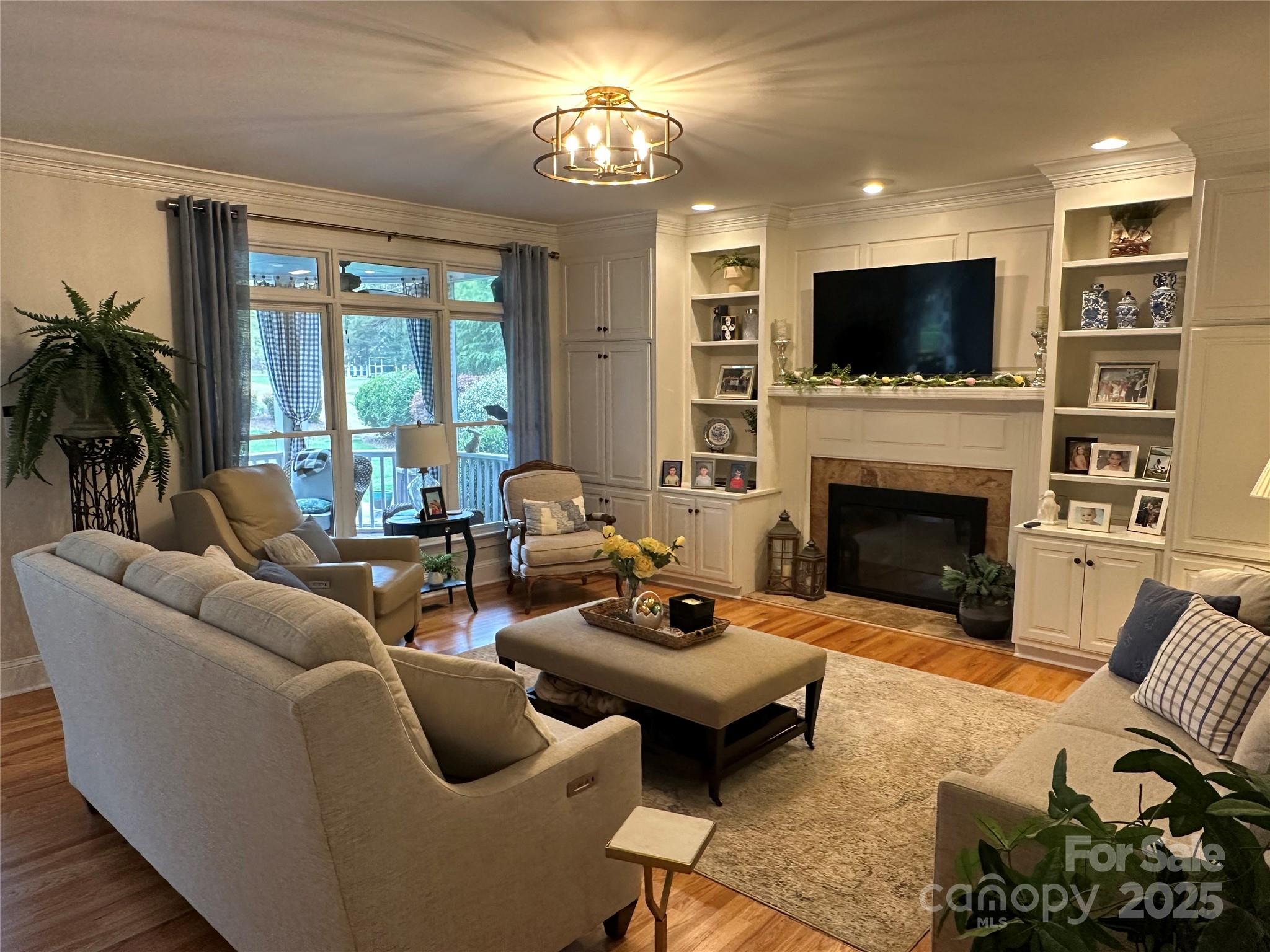 19622 River Falls Drive Davidson, NC 28036 - Photo 5 of 25 a living room with furniture fireplace and a flat screen tv