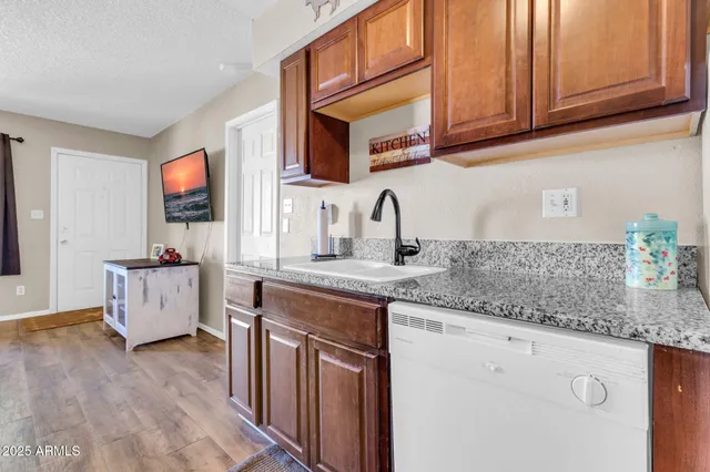 a kitchen with stainless steel appliances granite countertop a sink stove and cabinets