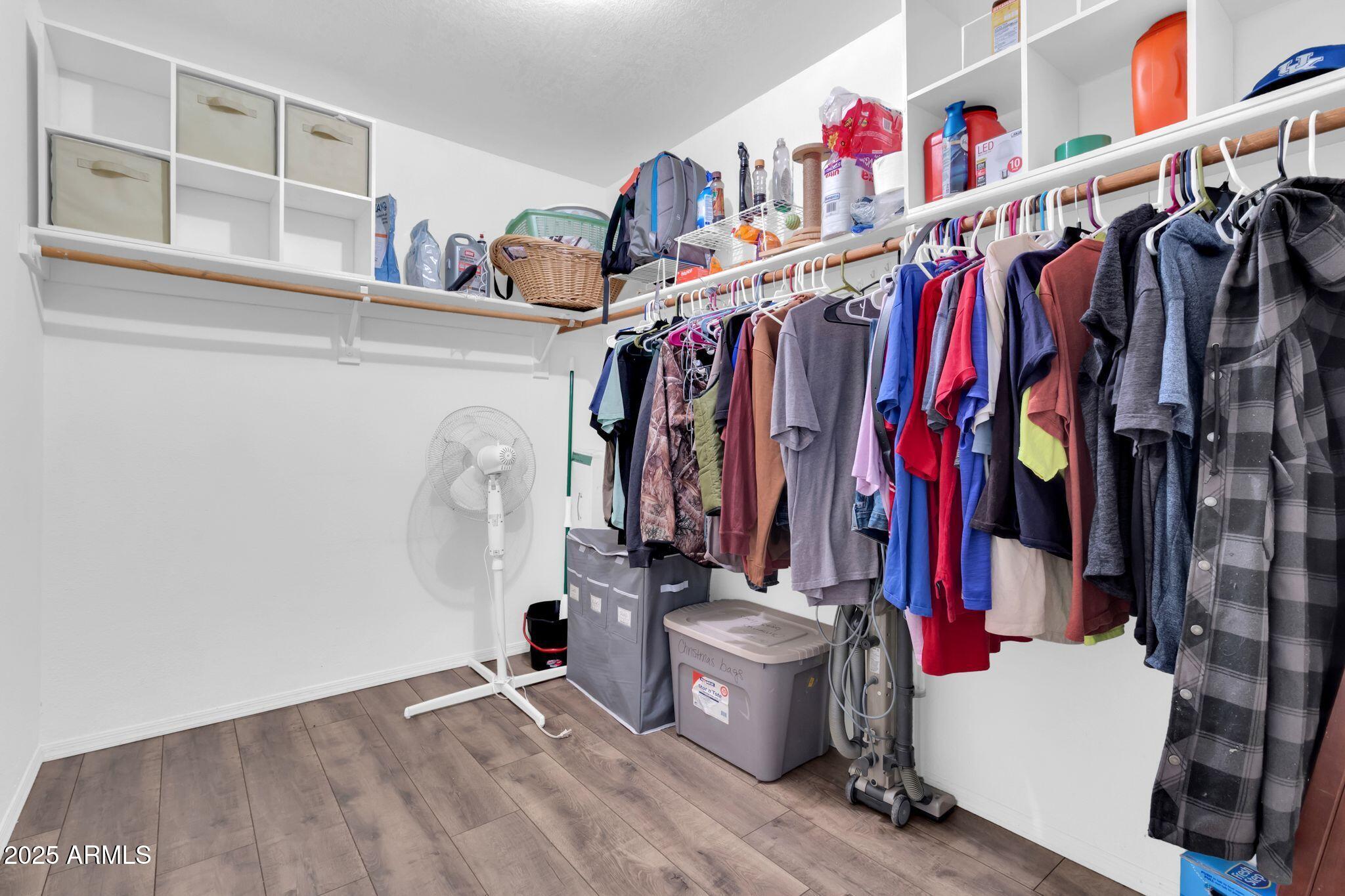 1440 North Idaho Road, Unit 2060 Apache Junction, AZ 85119 - Photo 17 of 24 a view of walk in closet with clothes and shoes