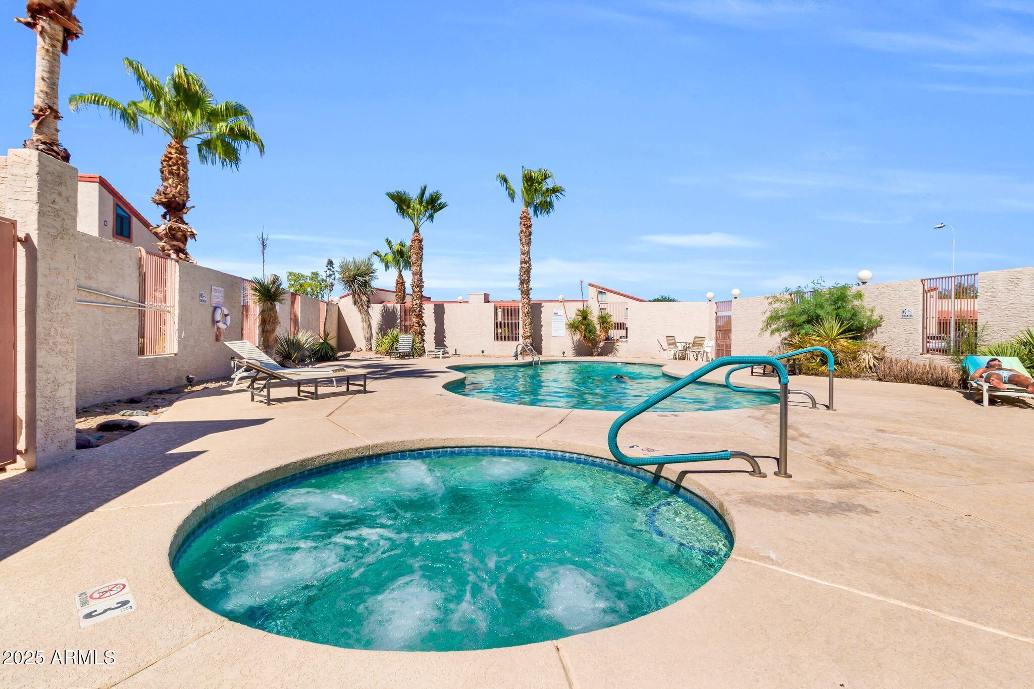 1440 North Idaho Road, Unit 2060 Apache Junction, AZ 85119 - Photo 20 of 24 a view of a swimming pool with a yard