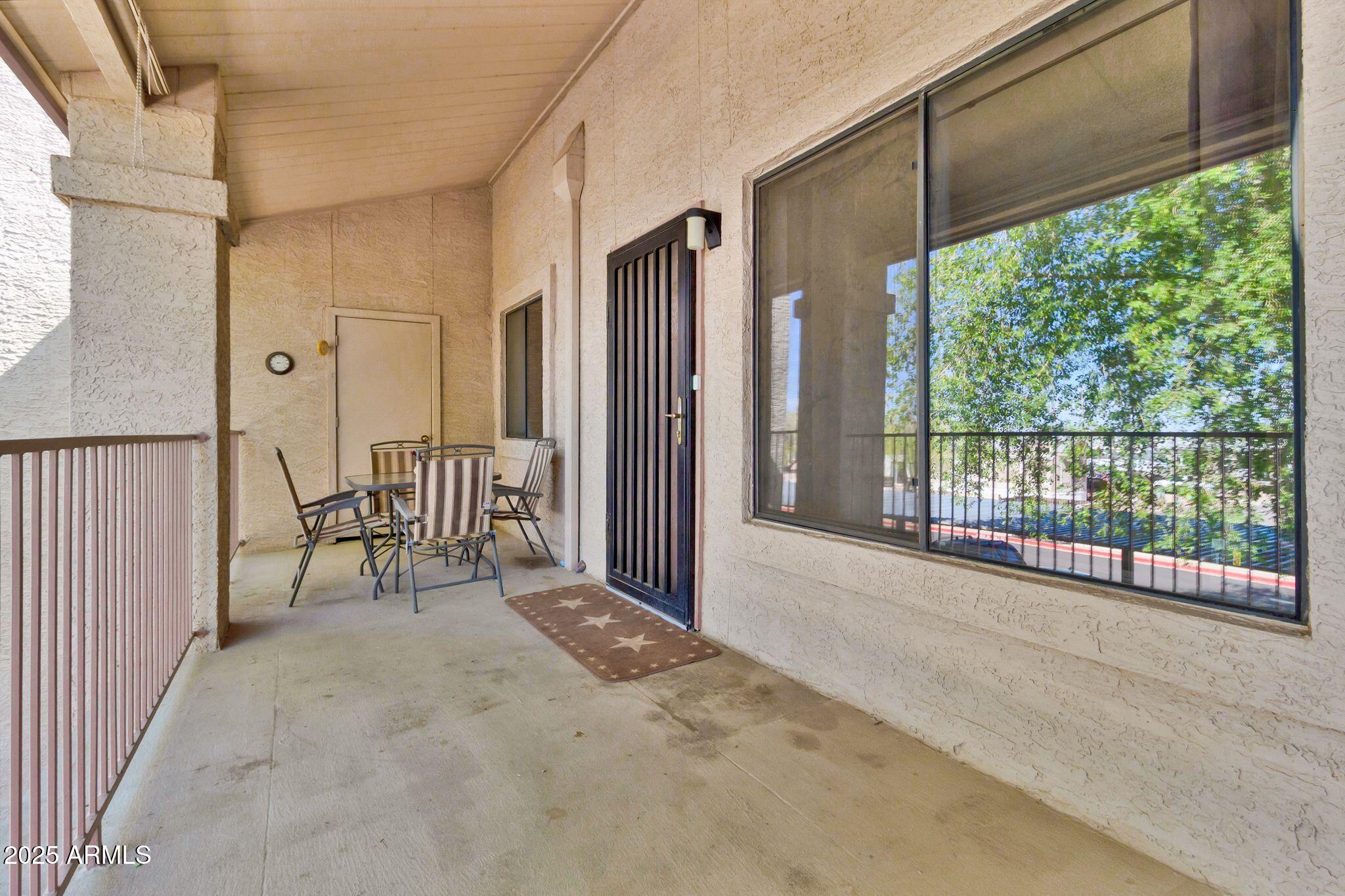 1440 North Idaho Road, Unit 2060 Apache Junction, AZ 85119 - Photo 4 of 24 a view of a porch with wooden floor and outdoor space