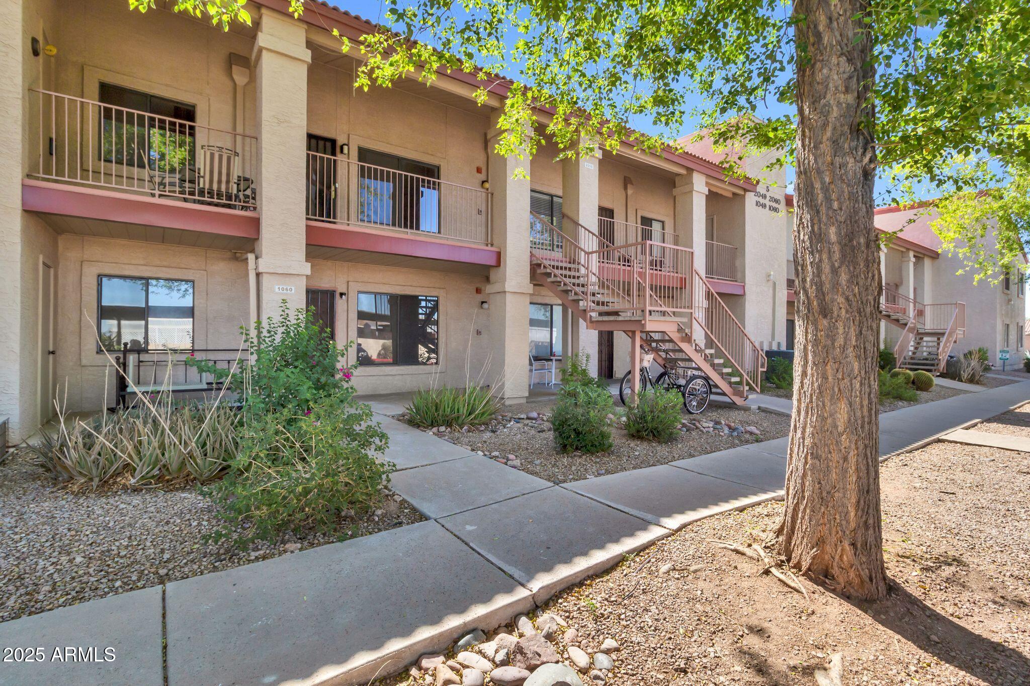 1440 North Idaho Road, Unit 2060 Apache Junction, AZ 85119 - Photo 6 of 24 a front view of a house with garden