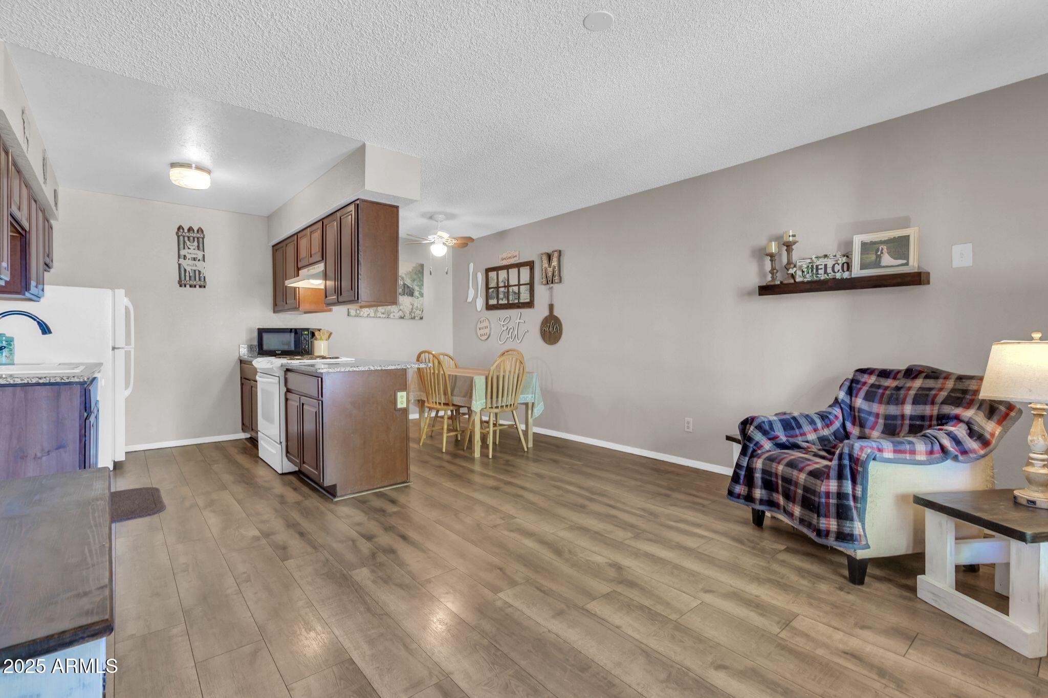 1440 North Idaho Road, Unit 2060 Apache Junction, AZ 85119 - Photo 23 of 24 a living room with furniture and a wooden floor