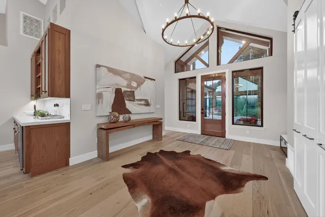 a kitchen with a refrigerator a sink and chairs