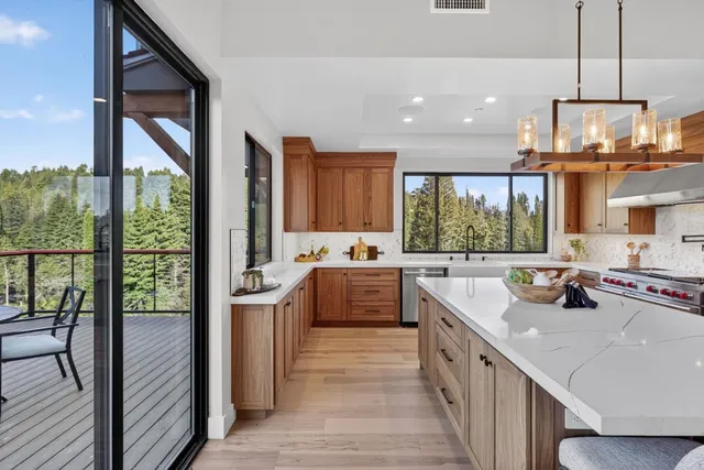 a bathroom with a granite countertop sink a toilet a large mirror and shower