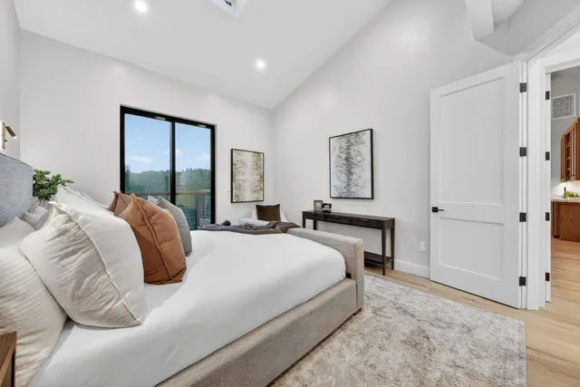 a bed room with a bed and a large window