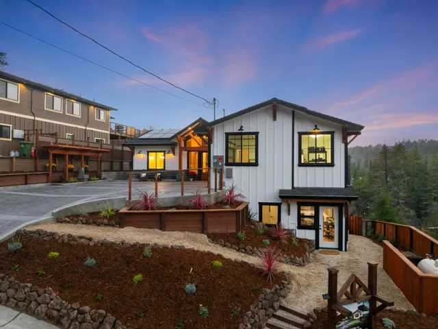 an aerial view of a house with a yard