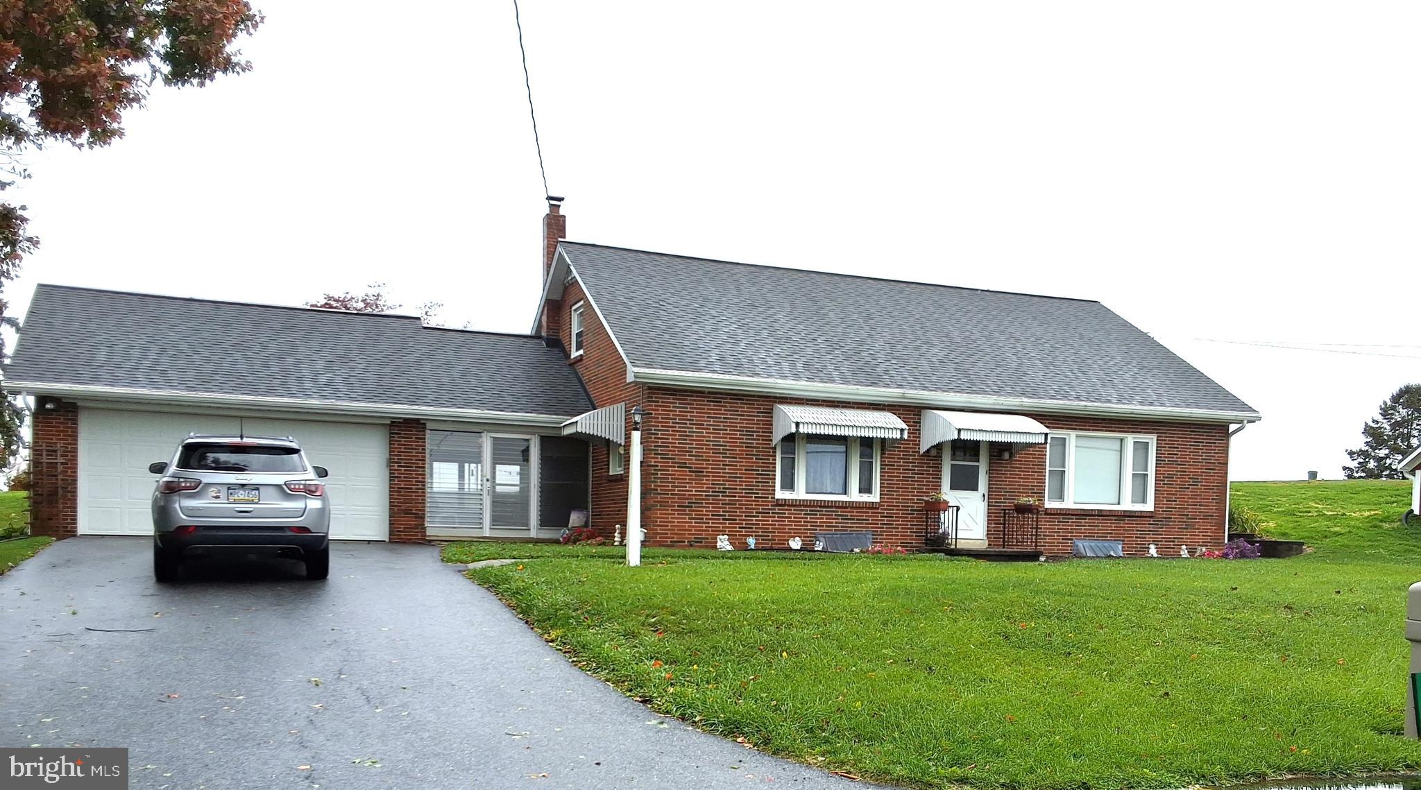 a front view of a house with a garden and yard