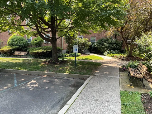 a swimming pool with outdoor seating and garden