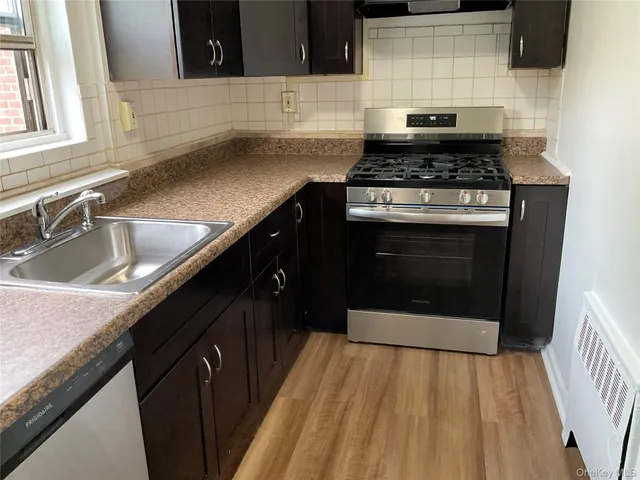 a kitchen with a sink and a refrigerator