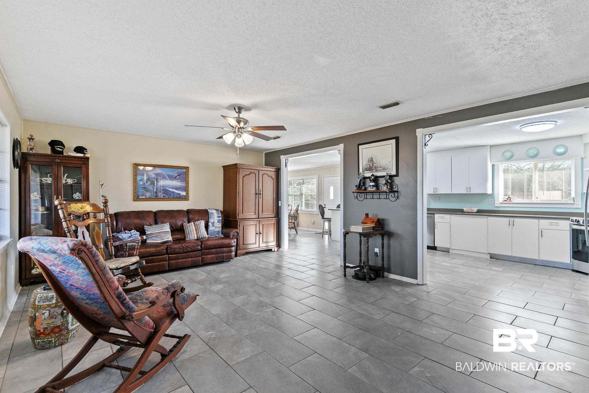 21267 Loop Road Andalusia, AL 36421 - Photo 15 of 72 Living area with plenty of natural light, a textured ceiling, and a ceiling fan