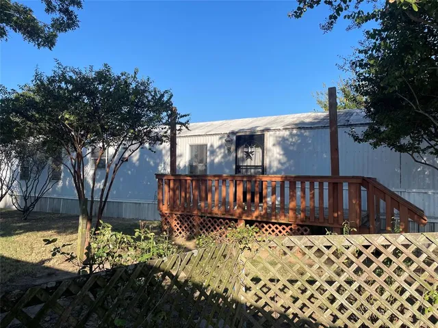 a view of a yard with wooden fence