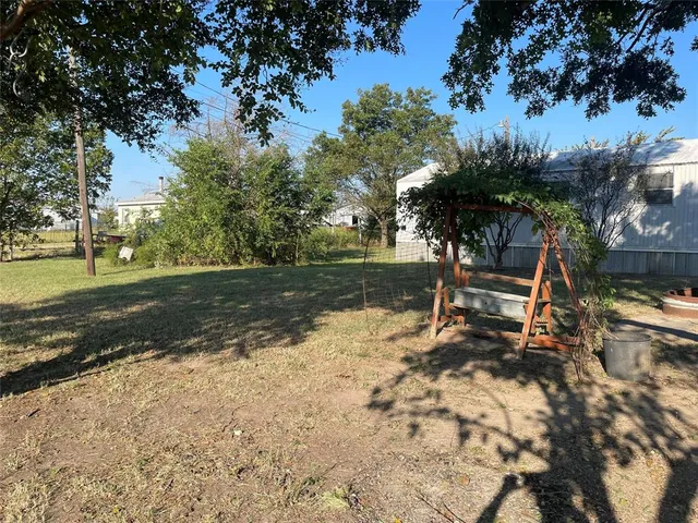 a view of a park that has a tree on the side of it