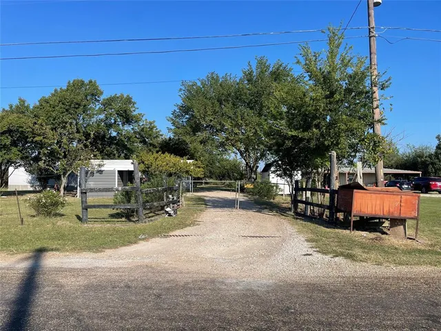 a backyard of a house with oven and tree