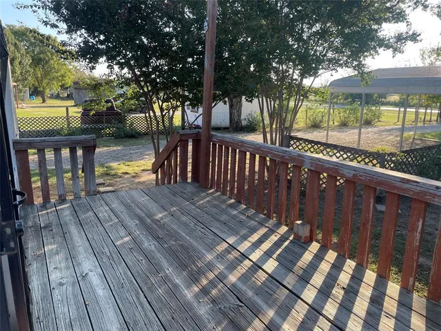 a view of deck with patio and wooden floor