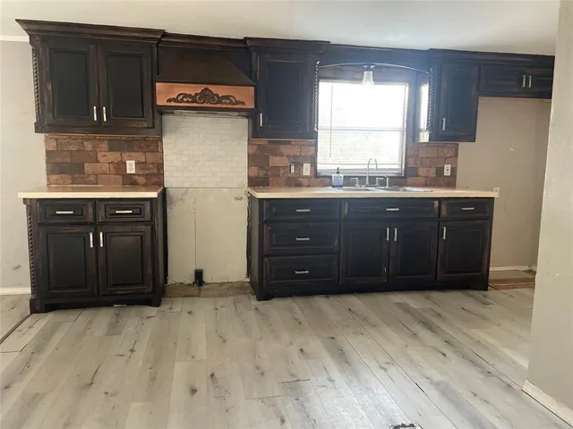 a kitchen with a refrigerator and window