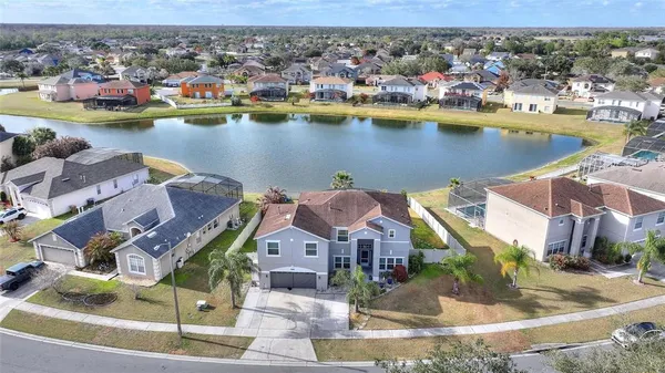 an aerial view of a house with a lake view