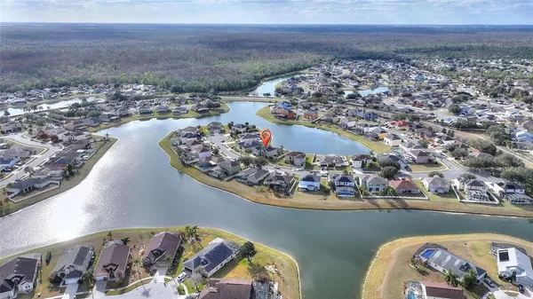 an aerial view of a house with a swimming pool and a fountain